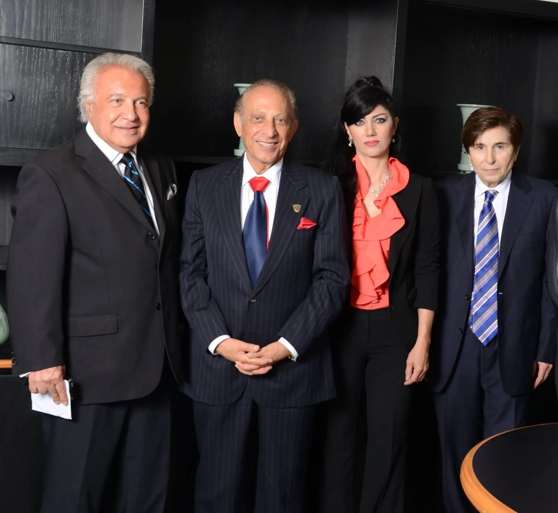 A group of people in suits and ties standing next to each other.